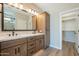 Modern bathroom with double vanity and walk-in closet at 389 E Bracciano Ave, Queen Creek, AZ 85140