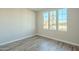 Bright bedroom with triple windows and wood-look flooring at 389 E Bracciano Ave, Queen Creek, AZ 85140