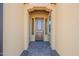 Front entry with a brown door and a paved walkway at 389 E Bracciano Ave, Queen Creek, AZ 85140
