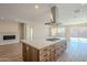 Open concept kitchen with island and fireplace at 389 E Bracciano Ave, Queen Creek, AZ 85140
