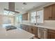 Bright kitchen with an island, stainless steel appliances, and access to backyard at 389 E Bracciano Ave, Queen Creek, AZ 85140