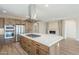 Modern kitchen with island, stainless steel appliances and fireplace at 389 E Bracciano Ave, Queen Creek, AZ 85140