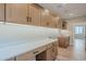 Well-lit laundry room with custom cabinetry and a built-in workspace at 389 E Bracciano Ave, Queen Creek, AZ 85140