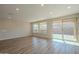 Living room featuring hardwood floors and sliding glass doors leading to the backyard at 389 E Bracciano Ave, Queen Creek, AZ 85140
