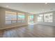 Spacious living room with hardwood floors and large windows offering natural light at 389 E Bracciano Ave, Queen Creek, AZ 85140