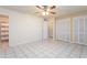 Large bedroom with tile floors, ceiling fan, and built-in closet at 3926 W Glendale Ave, Phoenix, AZ 85051