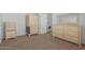 Well-lit bedroom featuring wood furniture and neutral carpeting at 5201 W Camelback Rd # A187, Phoenix, AZ 85031