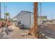 Mobile home exterior with covered patio, palm trees, and gravel landscaping at 5201 W Camelback Rd # A187, Phoenix, AZ 85031