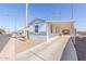 Single-wide manufactured home with covered carport and street view at 5201 W Camelback Rd # A187, Phoenix, AZ 85031