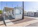 Single-wide manufactured home with covered carport and landscaped yard at 5201 W Camelback Rd # A187, Phoenix, AZ 85031