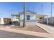Single-wide manufactured home with covered carport and mature palm trees at 5201 W Camelback Rd # A187, Phoenix, AZ 85031