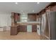 Kitchen with wood cabinets, stainless steel refrigerator, and tile floors at 5201 W Camelback Rd # A187, Phoenix, AZ 85031