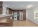 Kitchen with dark brown cabinets and stainless steel appliances at 5201 W Camelback Rd # A187, Phoenix, AZ 85031