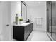 Clean bathroom with dark vanity, large mirror, and walk-in shower at 6862 E Joshua Tree Ln, Paradise Valley, AZ 85253