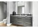 Powder room with dark gray vanity and modern fixtures at 6862 E Joshua Tree Ln, Paradise Valley, AZ 85253