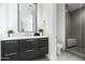 Contemporary bathroom with dark vanity and shower at 6862 E Joshua Tree Ln, Paradise Valley, AZ 85253