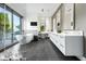 Modern bathroom with double vanity, soaking tub, and walk-in shower at 6862 E Joshua Tree Ln, Paradise Valley, AZ 85253