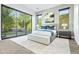 Bright bedroom with light gray bedding, and sliding glass doors to backyard at 6862 E Joshua Tree Ln, Paradise Valley, AZ 85253