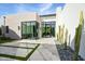 Contemporary home exterior with large windows and stone accents at 6862 E Joshua Tree Ln, Paradise Valley, AZ 85253