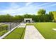 Landscaped backyard with modern stone fireplace and seating at 6862 E Joshua Tree Ln, Paradise Valley, AZ 85253