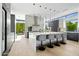 Modern kitchen with white island, grey cabinetry, and stainless steel appliances at 6862 E Joshua Tree Ln, Paradise Valley, AZ 85253