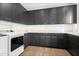 Laundry room with dark gray cabinets and new appliances at 6862 E Joshua Tree Ln, Paradise Valley, AZ 85253