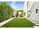 Landscaped side yard with stairs, hedges, and a seating area at 6862 E Joshua Tree Ln, Paradise Valley, AZ 85253