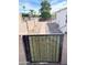 Landscaped backyard with wooden gate and gravel pathway at 8257 E Dutchman Dr, Mesa, AZ 85208