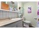 Clean bathroom with a single sink and tiled walls at 8257 E Dutchman Dr, Mesa, AZ 85208