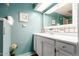 Clean bathroom with white vanity and teal walls at 8257 E Dutchman Dr, Mesa, AZ 85208