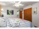 Bright bedroom featuring a floral comforter and large windows at 8257 E Dutchman Dr, Mesa, AZ 85208