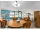 Cozy dining area with a round wooden table and teal accent wall at 8257 E Dutchman Dr, Mesa, AZ 85208