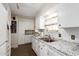Galley kitchen with granite countertops and white cabinetry at 8257 E Dutchman Dr, Mesa, AZ 85208
