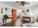 Home office with hardwood floors and built-in desk and mirror at 8257 E Dutchman Dr, Mesa, AZ 85208