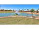 Pond with fountain in a lush golf course community, featuring palm trees at 109 S Agua Fria Ln, Casa Grande, AZ 85194