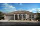 One-story home with tile roof, arched entry, and two-car garage at 1411 E Jacqueline Pl, Casa Grande, AZ 85122