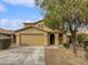 Two-story house with a tan facade, a two-car garage, and a landscaped front yard at 4042 W Kirkland Ave, San Tan Valley, AZ 85144