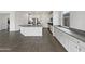 Modern kitchen with white cabinets and granite countertops at 4042 W Kirkland Ave, San Tan Valley, AZ 85144