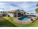 Inviting backyard oasis featuring a sparkling pool, spacious patio, and lush grass at 4112 E Tanglewood Dr, Phoenix, AZ 85048