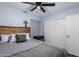 Bedroom with gray bedding, wooden headboard, and built-in closet at 4112 E Tanglewood Dr, Phoenix, AZ 85048
