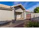 Welcoming front entry with a decorative gate and well manicured landscaping at 4112 E Tanglewood Dr, Phoenix, AZ 85048
