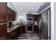 Kitchen boasts dark wood cabinets, granite counters, and stainless steel appliances at 4112 E Tanglewood Dr, Phoenix, AZ 85048