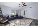 Relaxing living room with dark hardwood floors, sectional sofa and large TV at 4112 E Tanglewood Dr, Phoenix, AZ 85048