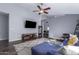 Spacious living room with hardwood floors, a comfy sectional sofa, and a ceiling fan at 4112 E Tanglewood Dr, Phoenix, AZ 85048