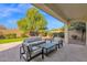 Covered patio with seating area and grassy backyard at 4630 S Amethyst Dr, Chandler, AZ 85249