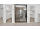 Main bathroom with a glass shower, double vanity, and two walk-in closets at 4630 S Amethyst Dr, Chandler, AZ 85249