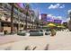 Vibrant outdoor plaza with shops, restaurants, and a water feature at 10269 N 115Th Ave, Youngtown, AZ 85363