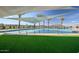 Relaxing pool area with shade structures and artificial turf at 1032 W Finch Dr, Queen Creek, AZ 85140