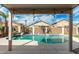 Relaxing kidney-shaped pool with covered patio at 15016 W Honeysuckle Ln, Surprise, AZ 85374