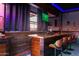 Bar with wood finishes and modern bar stools at 18208 W Happy Valley Rd, Wittmann, AZ 85361